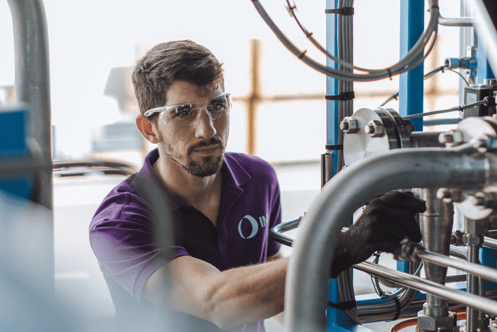 IMI engineer inspecting electrolyser piping and valves, ensuring safe and efficient green hydrogen production.