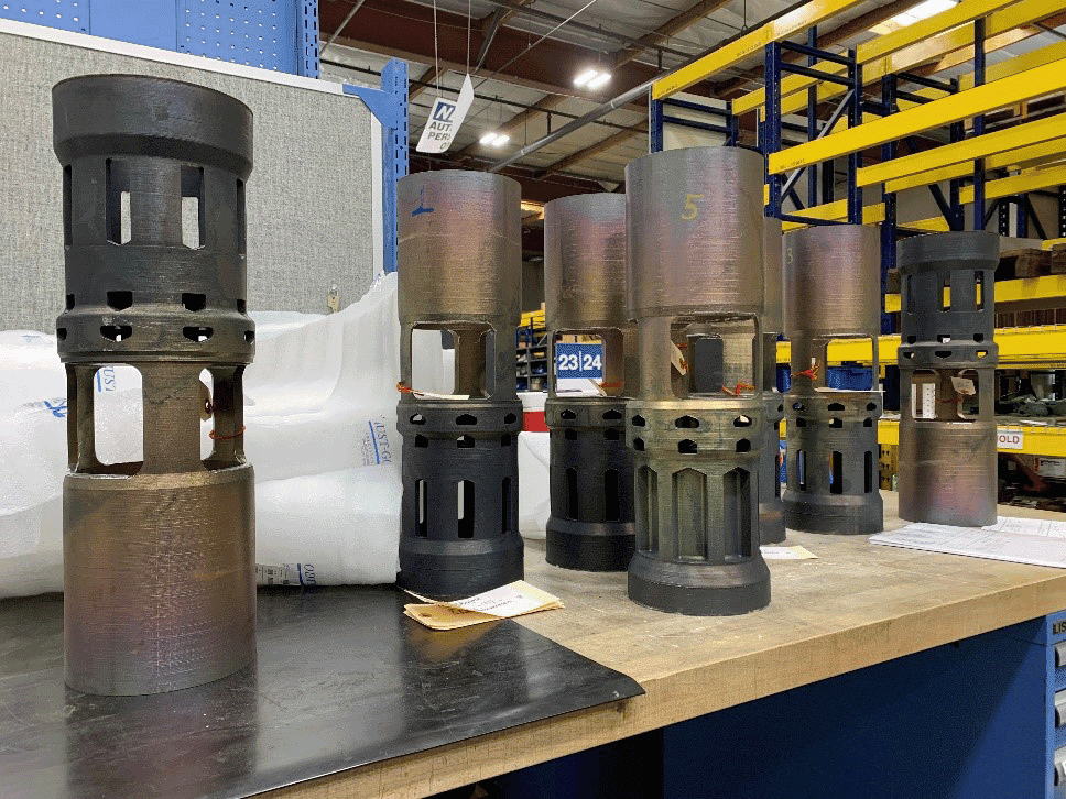 Multiple IMI CCI Valve Plugs with machined flow paths arranged on an industrial workbench.