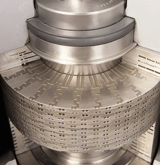 Typical DRAG® disk stack with perforated metal disks arranged in a cylindrical formation.