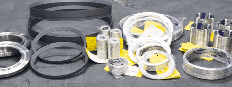Assortment of trim component replacement parts including metal rings, wire rolls, and packaging materials.