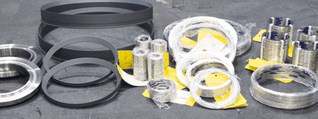Assortment of trim component replacement parts including metal rings, wire rolls, and packaging materials.